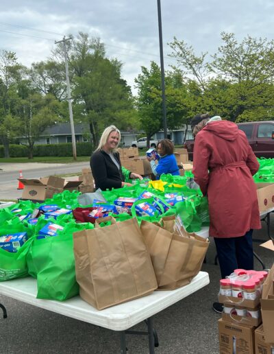 Image of Kristi Helping Bag Items for Food Truck